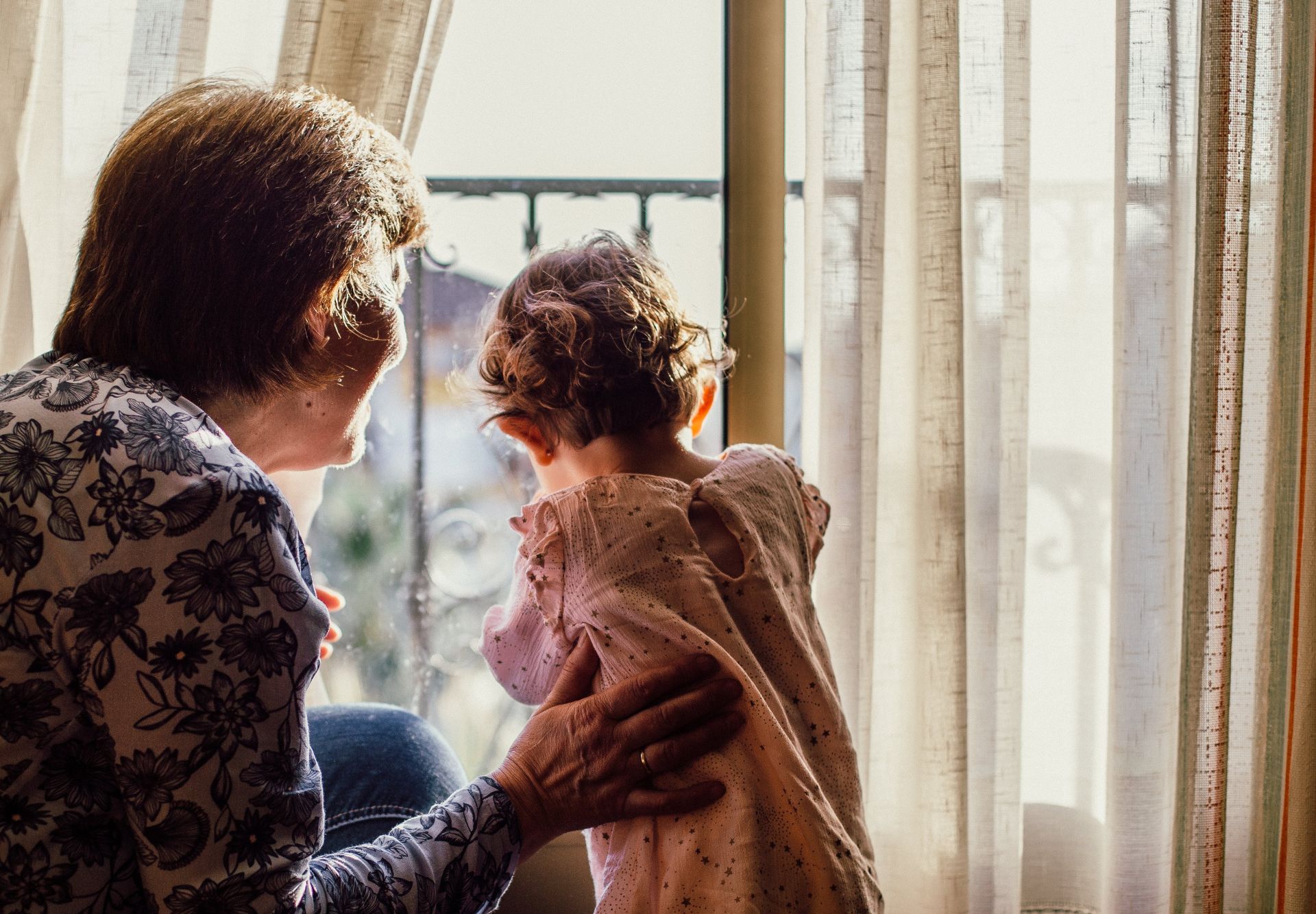 Woman Holding Baby Near Window